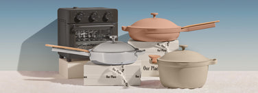 Collection of cookware including pots, pans, and a toaster oven on a light blue background