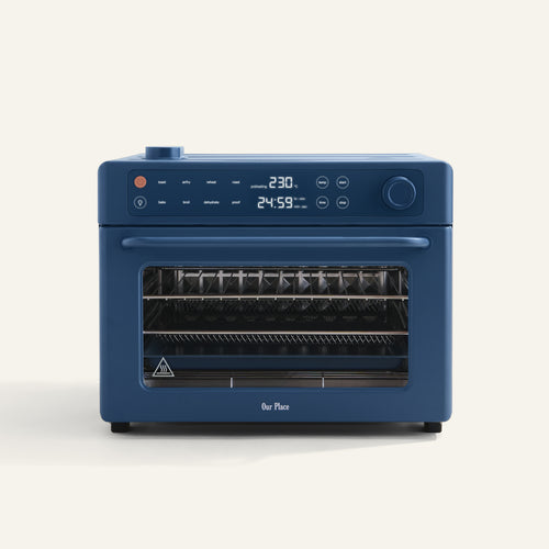 The Wonder Oven Pro is a blue mini oven with a digital display, buttons, two wire racks, and air fryer functionality, shown on a plain white background.