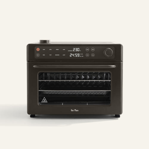 Wonder Oven Pro, a countertop convection mini oven with air fryer function, digital display, control buttons, and multiple racks is shown against a plain light background.