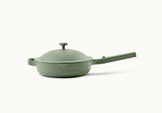 A sage green nonstick frying pan with a long handle and domed lid is shown against a plain white background.