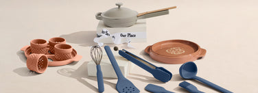 Set of kitchen utensils and cookware on a beige background